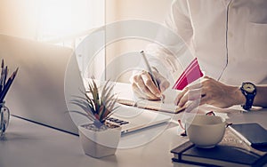 Man writing on notebook at desk