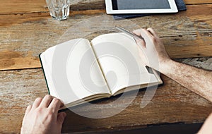 Man writing notepads sitting table home