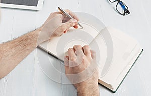 Man writing notepads table home