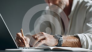 Focused man writing notes at desk photo
