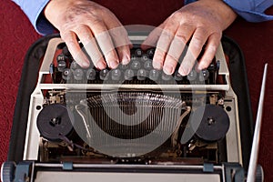 man writing on old typewriter