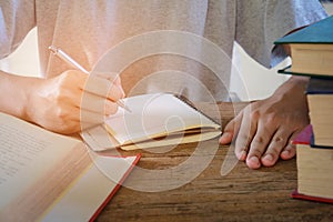 Man writing pen in book