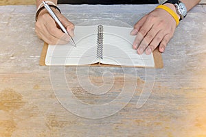 Man writing pen in book