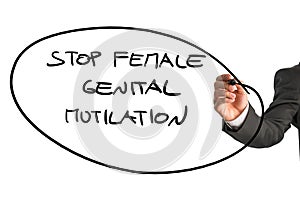 Man writing a sign Stop Female Genital Mutilation
