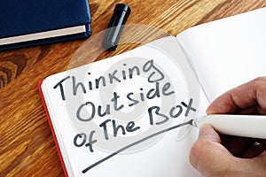 Man is writing Thinking Outside of The Box