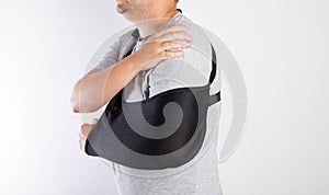 A man& x27;s arm in a black bandage for immobilization of the elbow joint after an injury. Bandage for rehabilitation