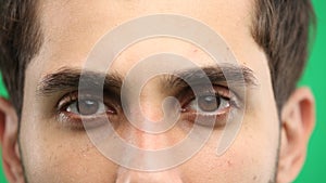 Man's eyes, close-up, on a green background