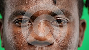 Man's eyes, close-up, on a green background