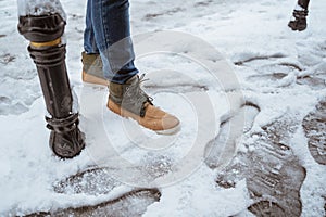 man& x27;s shoes stepping on a snow on the street