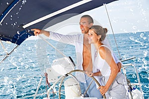 Man on yacht wheel pointing to horizon