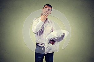 Man yawning with a pillow in hand. Sleep deprivation, burnout photo