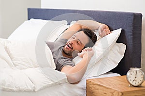 Man yawns in bed