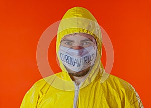 Man in yellow chemical protection suit and face protective mask coronavirus. Without glasses.