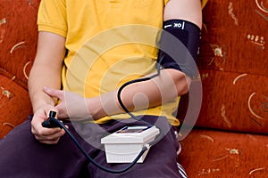 Man in yellow shirt is checking blood pressure