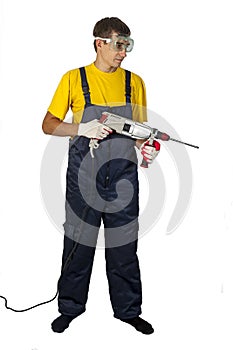 Man in yellow shirt in coveralls with the drill on an white background