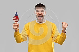 Man in yellow sweatshirt with flag of america