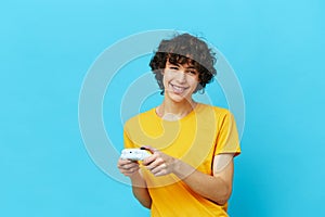 man yellow T-shirt with joystick video games isolated backgrounds