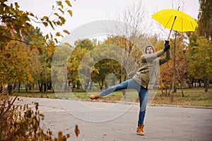 Man with yellow umbrella caught in gust of wind outdoors