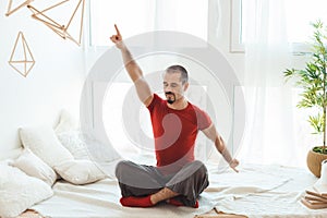 Man in a yoga pose does gymnastics.
