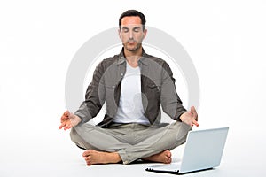 Man in yoga position with computer