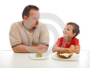 Man and young boy rival over food