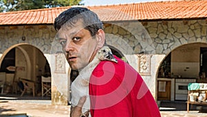 Man with young duck in his arms.