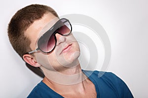 Man young handsome athlete with sunglasses and t-shirt
