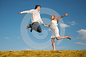 Man and young woman jumping