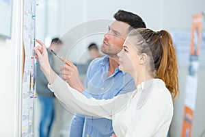 Man and young woman working together in office