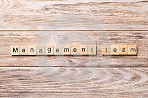 Managament team word written on wood block. managament team text on wooden table for your desing, concept