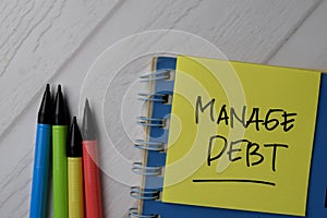 Manage Debt text on sticky notes with office desk