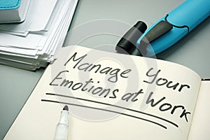 Manage your emotions at work handwritten on a page