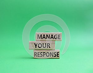 Manage your response symbol. Concept words Manage your response on wooden blocks. Beautiful green background. Business and Manage