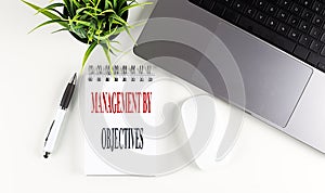 MANAGEMENT BY OBJECTIVES text on notebook with laptop, mouse and pen