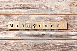Management word written on wood block. management text on table, concept