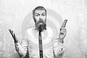 Manager or bearded man with long beard hold mobile phone