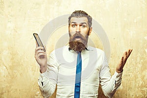 Manager or bearded man with long beard hold mobile phone