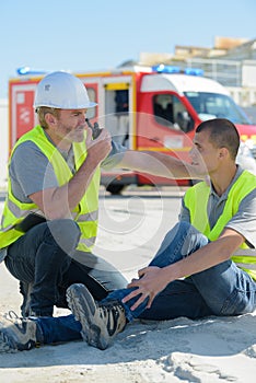 manager calling for help for construction worker injured at work