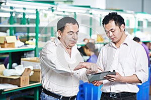 Manager and chinese worker in factory, Managing and cooperation