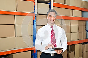 Manager With Clipboard In Distribution Warehouse