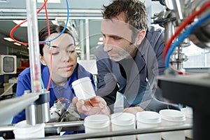 manager controlling employees during work in production centre