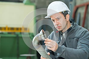 manager controlling pipe in factory photo
