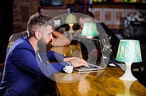 Manager create post enjoy coffee. Hipster freelancer work online drinking coffee. Coffee break concept. Man bearded