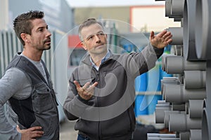 Manager dicussing aboout steel pipes circle pipe in factory