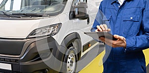 Manager with a digital tablet on the background of delivery van. Fleet management