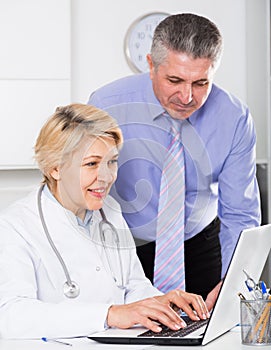 Manager and doctor reading news