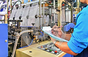 Manager engineer checking automated production line Plastic bag