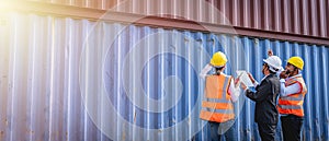 A manager and engineers inspecting the shipping container.