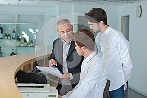 Manager explaining something to employee in reception