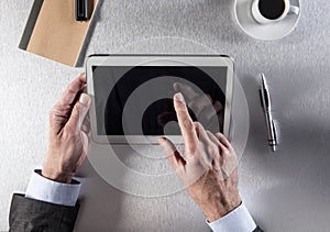 Manager hands working at the office, typing on his tablet